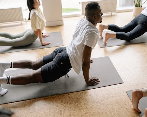 Group of people participating in a fitness class in a bright room